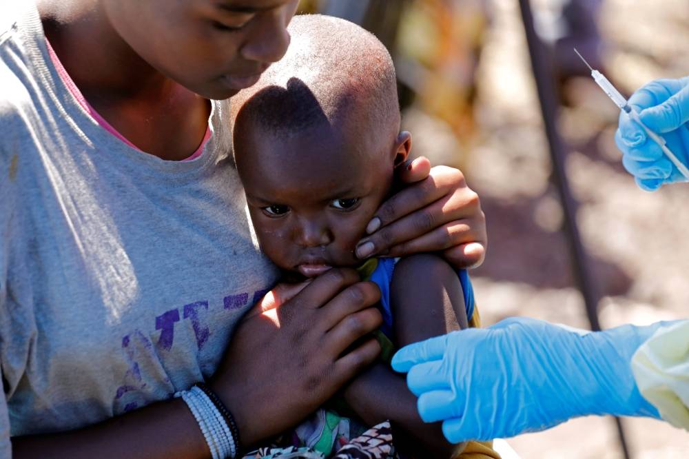 A child reacts as a health worker injects her with the Ebola vaccine, in Goma, Democratic Republic of Congo, August 5, 2019. -Reuters