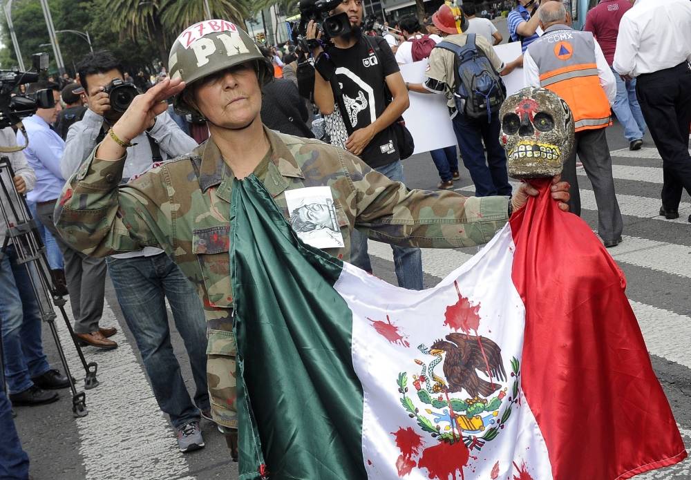 In this file photo taken on September 26, 2016 Mexican activist Julia Klug takes part in a protest in Mexico City, commemorating the second anniversary of the disappearance of the Ayotzinapa students. -AFP