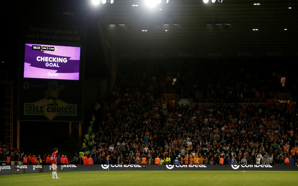 The big screen displays a VAR review message after Wolverhampton Wanderers' Ruben Neves scores their first goal against Manchester United at Molineux Stadium, Wolverhampton, Britain, on Monday. — Reuters
