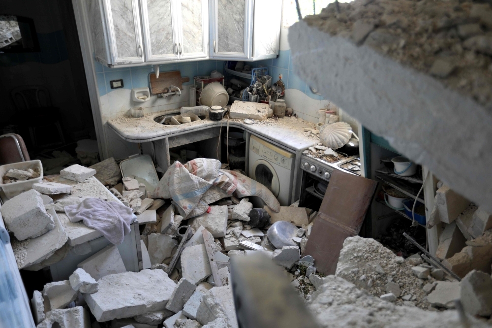 Blocks of cement and rubble are scattered in the kitchen of a house after it was hit during reported air strikes by pro-regime forces in the village of Beinin, north of Maaret Al-Numan, in the northern Idlib province, on Tuesday. — AFP