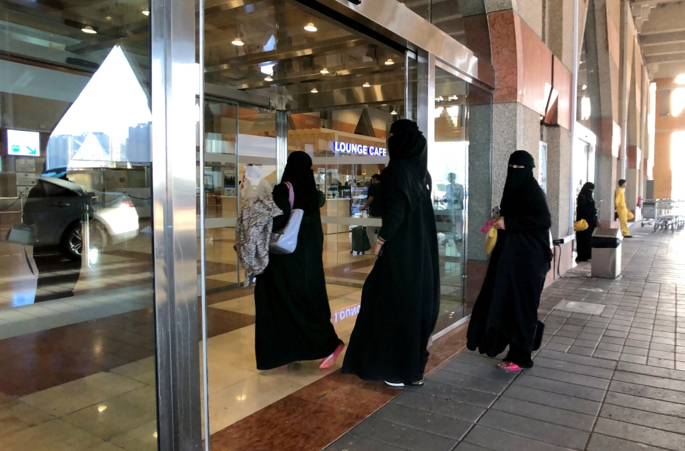 A Saudi woman walks with her luggage as she arrives at King Fahd International Airport in Dammam in this Aug. 5, 2019 file photo — Reuters