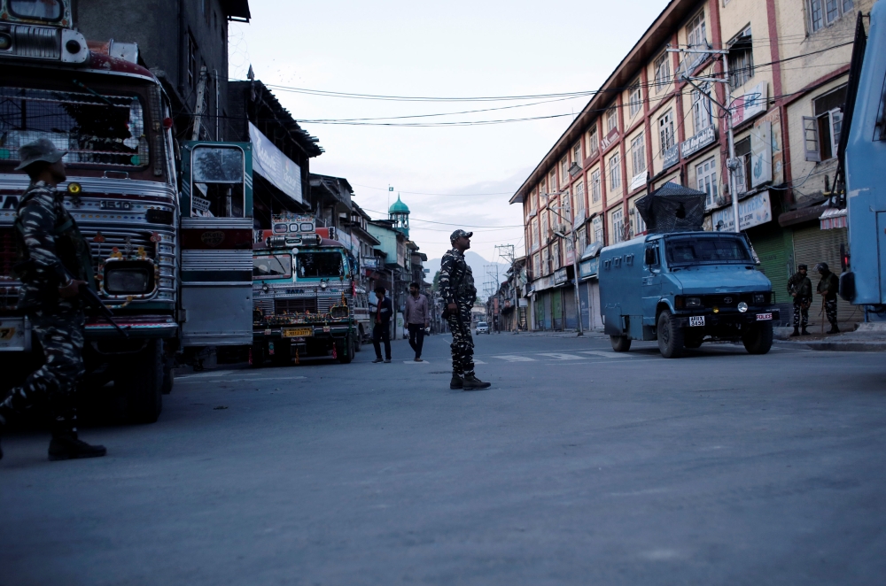 Indian security force personnel stand guard on a deserted road during restrictions after scrapping of the special constitutional status for Kashmir by the Indian government, in Srinagar, India, on Tuesday. — Reuters