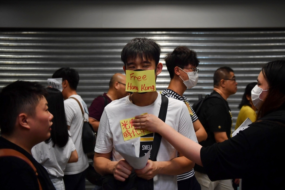 Anti-extradition protesters gather at Kwai Fong MTR station in Hong Kong on Tuesday. — AFP