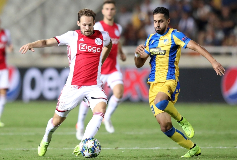 Ajax's defender defender Daley Blind (L) vies for the ball with APOEL's midfielder Musa Suliman during the UEFA Champions League playoff football match between Cyprus' APOEL Nicosia and Netherland's Ajax Amsterdam at the GSP stadium in Nicosia, on Tuesday. — AFP