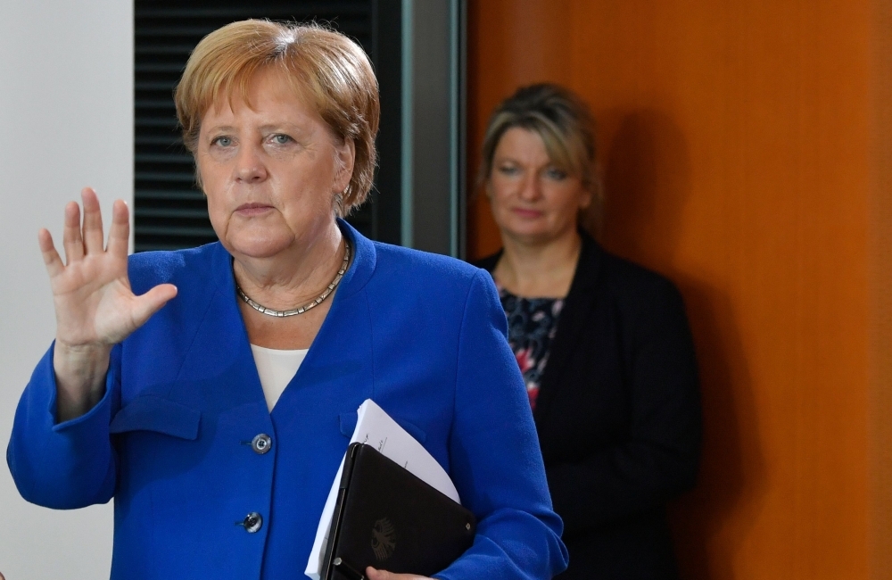 German Chancellor Angela Merkel, left, arrives for the weekly Cabinet meeting at the Chancellery in Berlin on Wednesday. — AFP