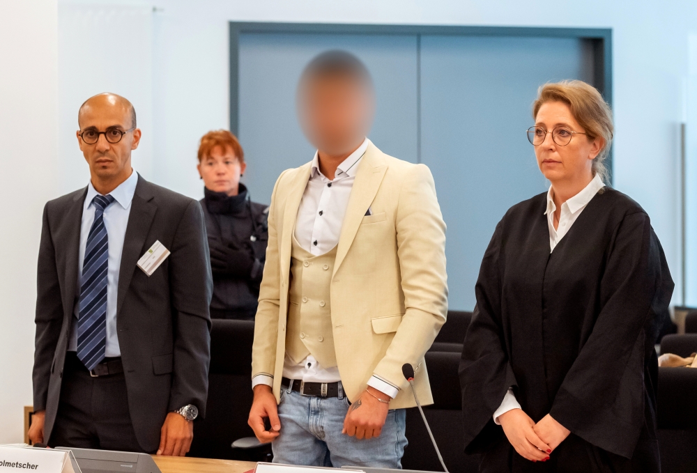 Alaa Sheikhi., suspected of being responsible for the stabbing of Daniel H. in Chemnitz, his interpreter and lawyer Ricarda Lang arrive at a court in Dresden, Germany, on Thursday. — Reuters