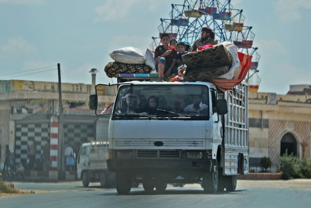 Syrian civilians flee a conflict zone in Syria's rebel-held northwestern region of Idlib, where government bombardment has killed hundreds since late April, near Maar Shurin on the outskirts of Maaret Al-Numan, on Thursday. — AFP