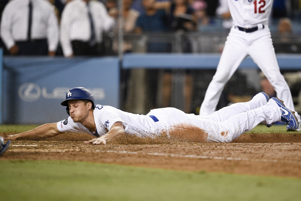 Los Angeles Dodgers shortstop Corey Seager (5) dives to score a run for during the ninth inning against the Toronto Blue Jays at Dodger Stadium in Los Angeles, CA, USA, on Thursday. — Reuters