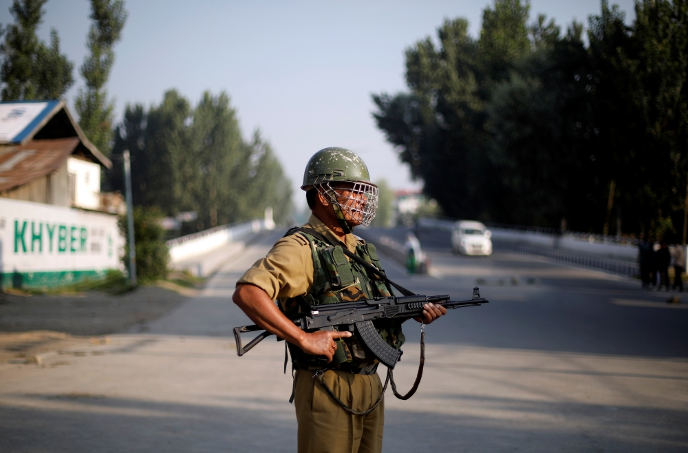 An Indian security personnel stands guard on a deserted road during restrictions after scrapping of the special constitutional status for Kashmir by the Indian government, in Srinagar, India, on Friday. — Reuters