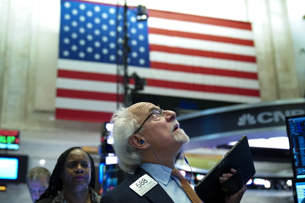 Traders and financial professionals work at the opening bell on the floor of the New York Stock Exchange in New York City in this June 3, 2019 file photo. — AFP