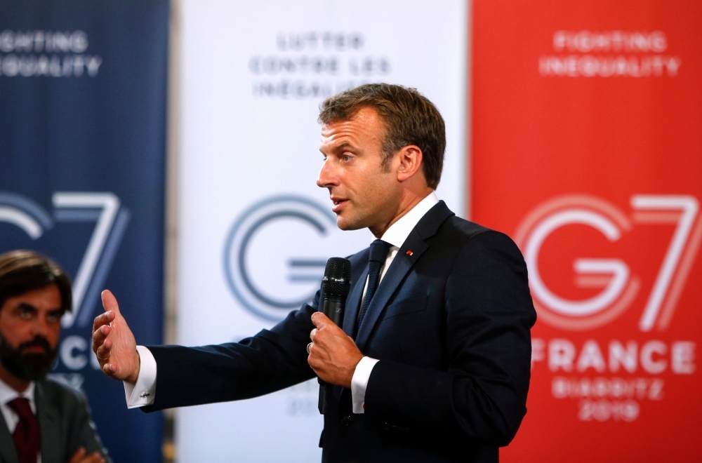 French President Emmanuel Macron delivers a speech on environment and social equality to business leaders on the eve of the G7 summit, in Paris on Friday. — AFP