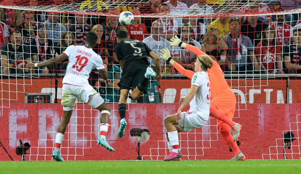 Dortmund's Moroccan defender Achraf Hakimi heads the ball to score the 1-2 goal past Cologne's German goalkeeper Timo Horn (R) during the German first division Bundesliga football match 1 FC Cologne vs BVB Borussia Dortmund in Cologne, western Germany, on Friday. —  AFP