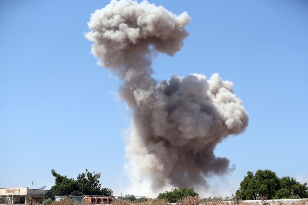 Smoke billows following a reported regime air strike on the eastern outskirts of Maaret Al-Numan in Syria's northern province of Idlib on Saturday. -AFP
