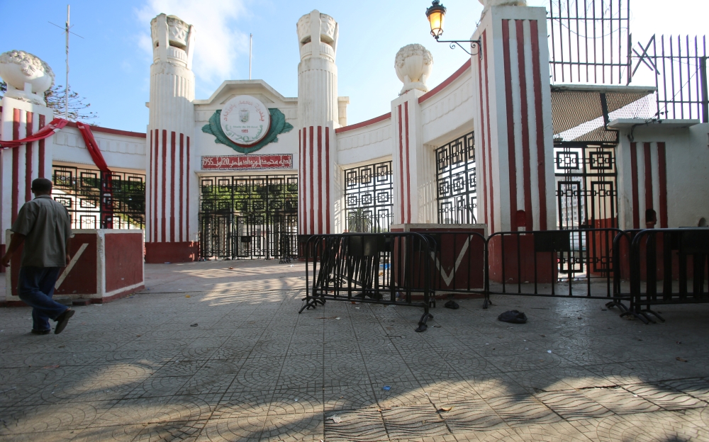 A man walks past the main gate of the stadium of the rap concert where thousands had gathered to see local rap star Abderraouf Derradji, known as 'Soolking' in Algiers. REUTERS