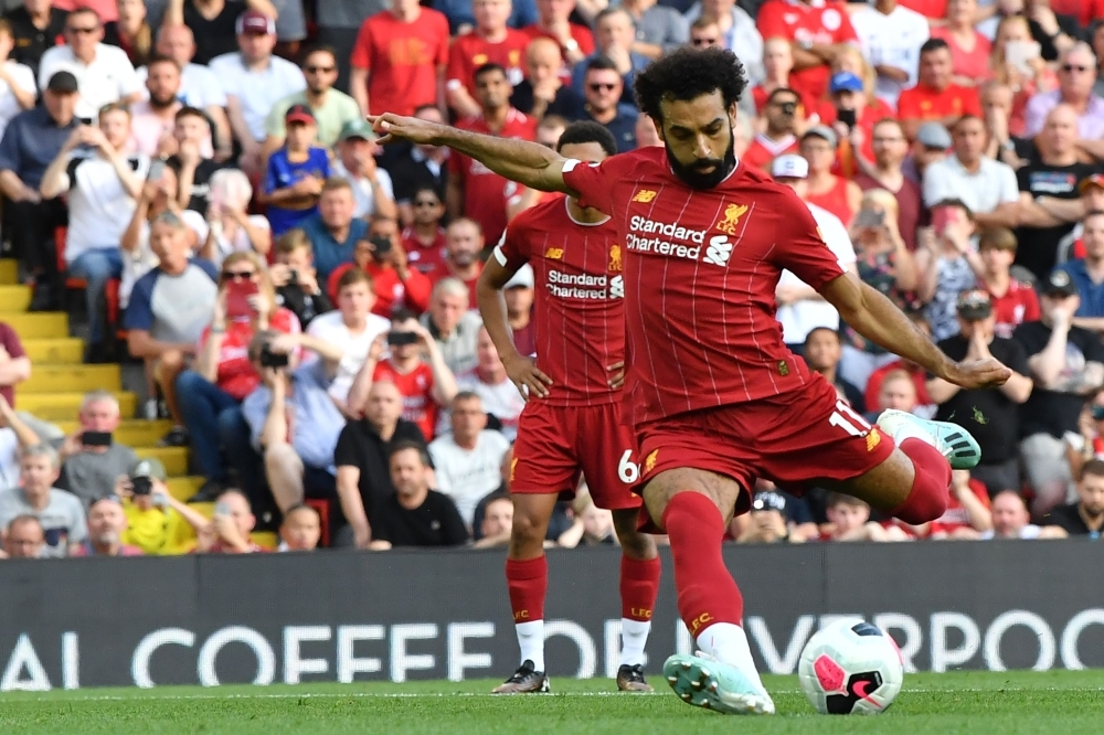 Liverpool's Egyptian midfielder Mohamed Salah shoots to score their second goal from the penalty spot during the English Premier League football match between Liverpool and Arsenal at Anfield in Liverpool, north west England, on Saturday. — AFP