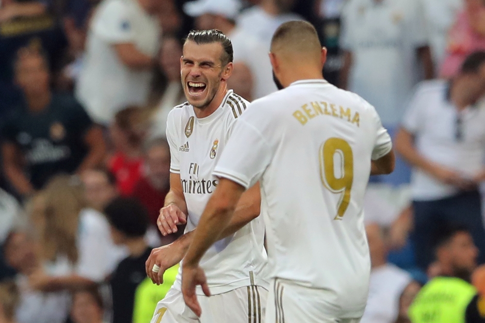 Real Madrid's Karim Benzema celebrates scoring their first goal with Gareth Bale. REUTERS