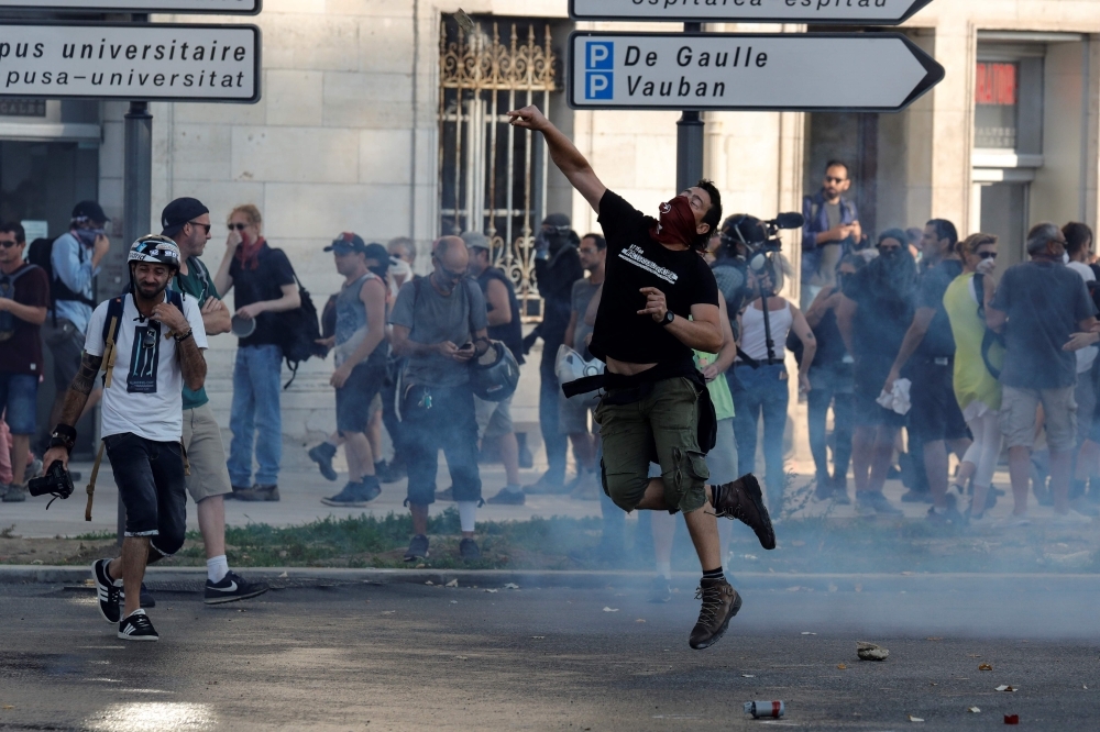 A man lobs a stone during a protest in the city of Bayonne, south-west France on Saturday, on the sidelines of the annual G7 Summit attended by the leaders of the world's seven richest democracies, Britain, Canada, France, Germany, Italy, Japan and the United States taking place in the seaside resort of Biarritz. -Courtesy photo