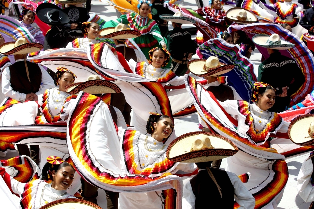 Couples dance to Mariachi traditional music to break the Guinness World Record of largest Mexican folk dance Dancers in Guadalajara, Jalisco state, Mexico, on Saturday.  -AFP