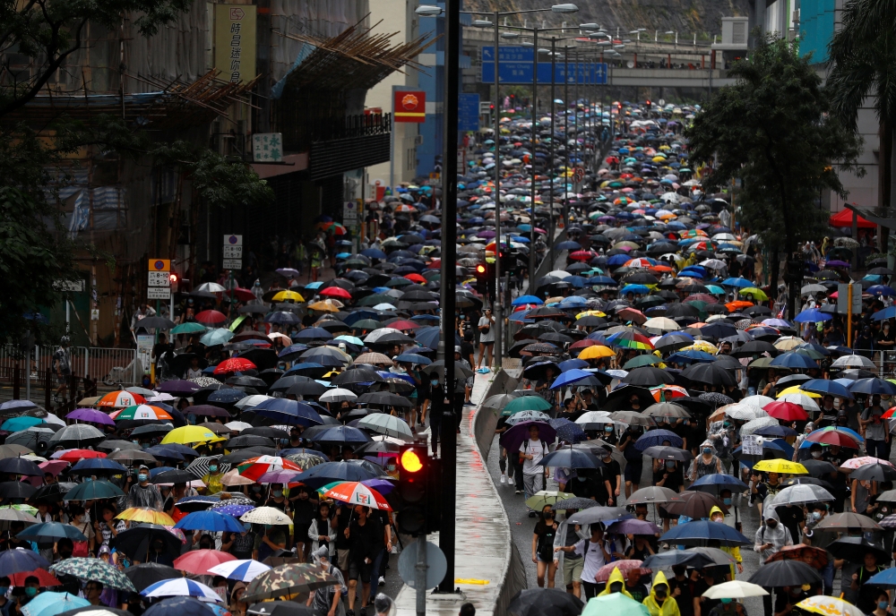 People march during a protest in Kwai Fong, in Hong Kong, on Sunday. -Reuters