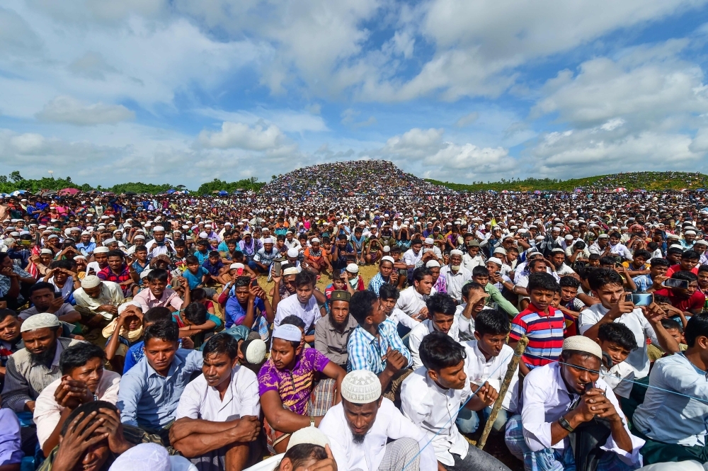 Rohingya refugees attend a ceremony organised to remember the second anniversary of a military crackdown that prompted a massive exodus of people from Myanmar to Bangladesh, at the Kutupalong refugee camp in Ukhia on Sunday. -AFP