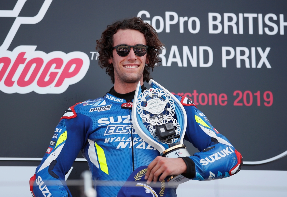 Team Suzuki Ecstar's Alex Rins celebrates on the podium after winning the British MotoGP race with Repsol Honda's Marc Marquez who finished second and Monster Energy Yamaha's Maverick Vinales who finished third at the Silverstone Circuit, Silverstone, Britain, on Sunday. — Reuters