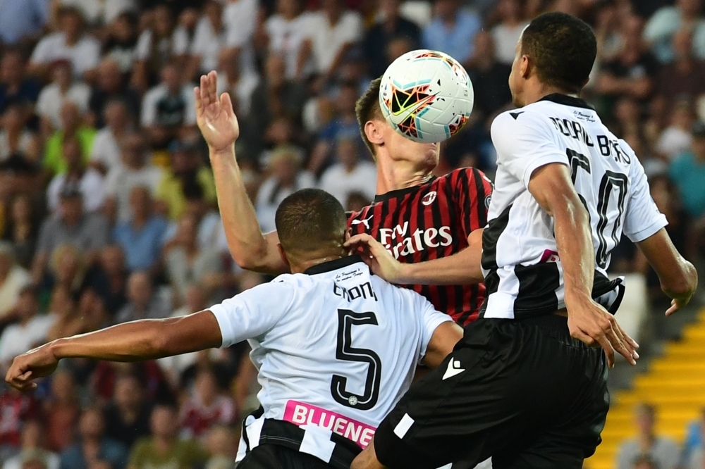 (From L) Udinese's Nigerian defender William Troost-Ekong, AC Milan's Polish forward Krzysztof Piatek and Udinese's Brazilian defender Rodrigo Becao go for a header during the Italian Serie A football match Udinese vs AC Milan at the Friuli stadium in Udine, on Sunday. — AFP