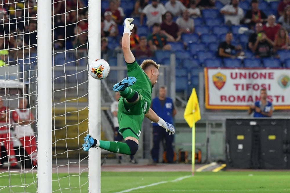 Genoa's Romanian goalkeeper Ionut Radu fails to stop Roma's third goal during the Italian Serie A football match Roma vs Genoa at the Olympic stadium in Rome, on Sunday. — AFP