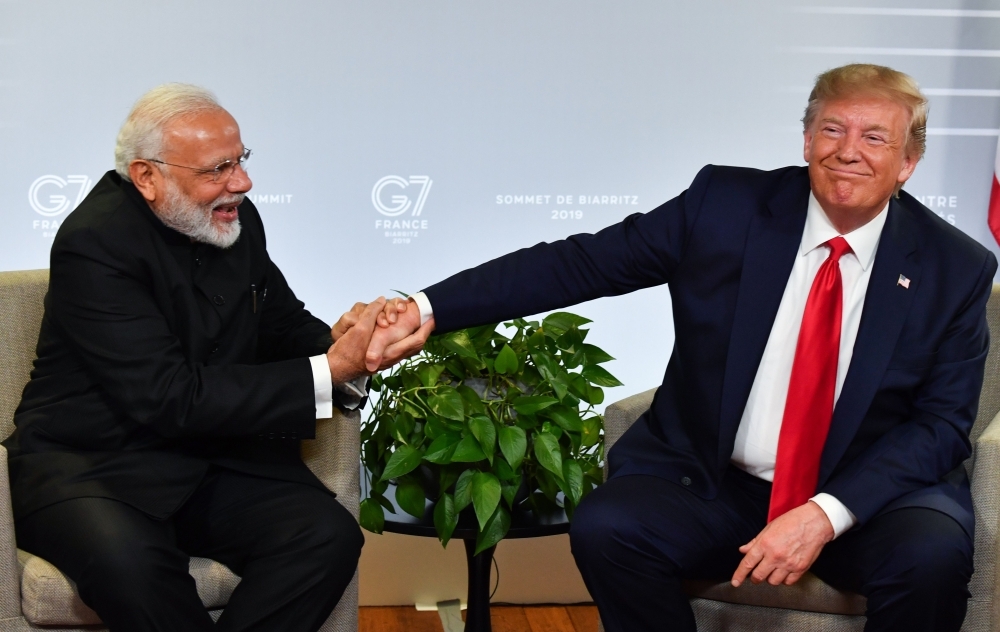 Indian Prime Minister Narendra Modi, left, and US President Donald Trump shakes hands as they speak during a bilateral meeting in Biarritz, south-west France on Monday, on the third day of the annual G7 Summit. — AFP