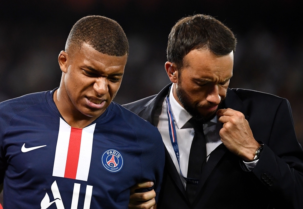 Paris Saint-Germain's French forward Kylian Mbappe leaves the pitch following an injury during the French L1 football match between Paris Saint-Germain (PSG) and Toulouse (TFC) at the Parc des Princes stadium in Paris, Sunday. — AFP