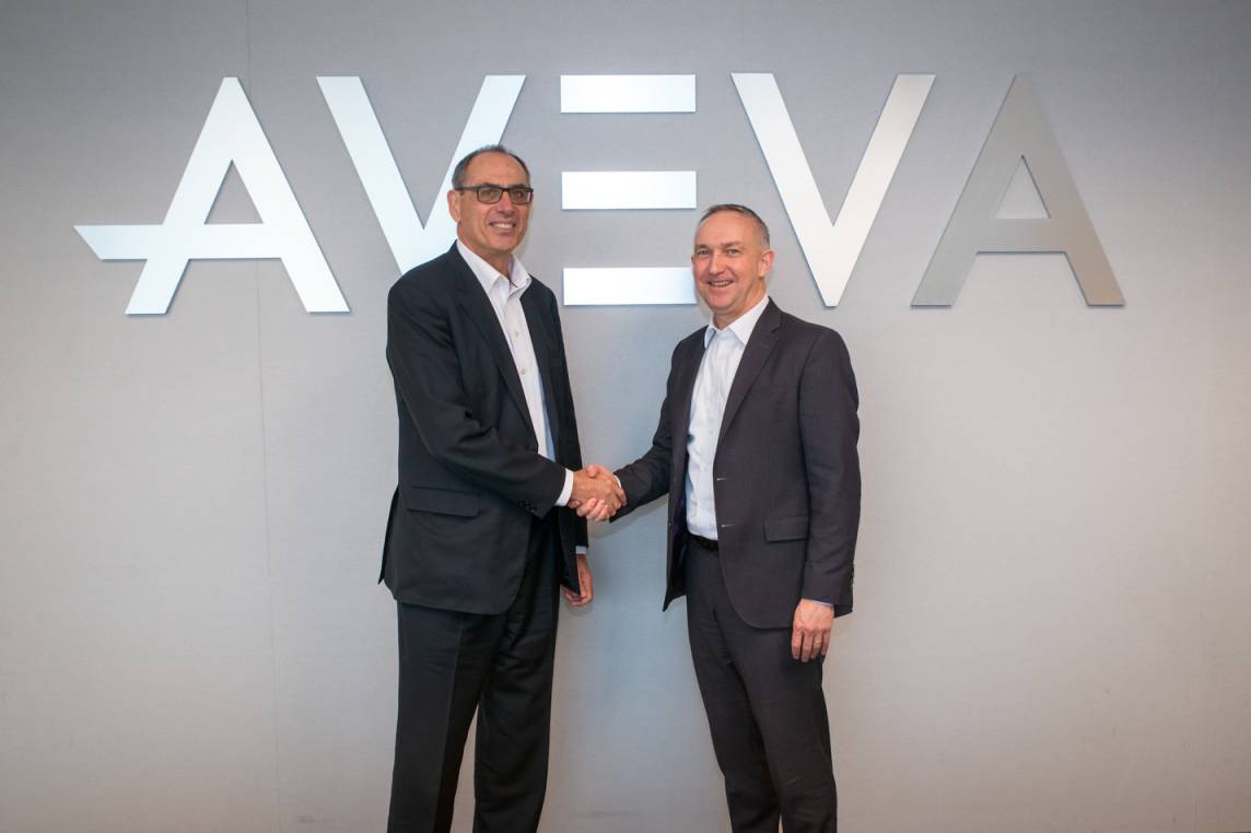 Worley CEO Andrew Wood and AVEVA CEO Craig Hayman shake hands after striking a deal