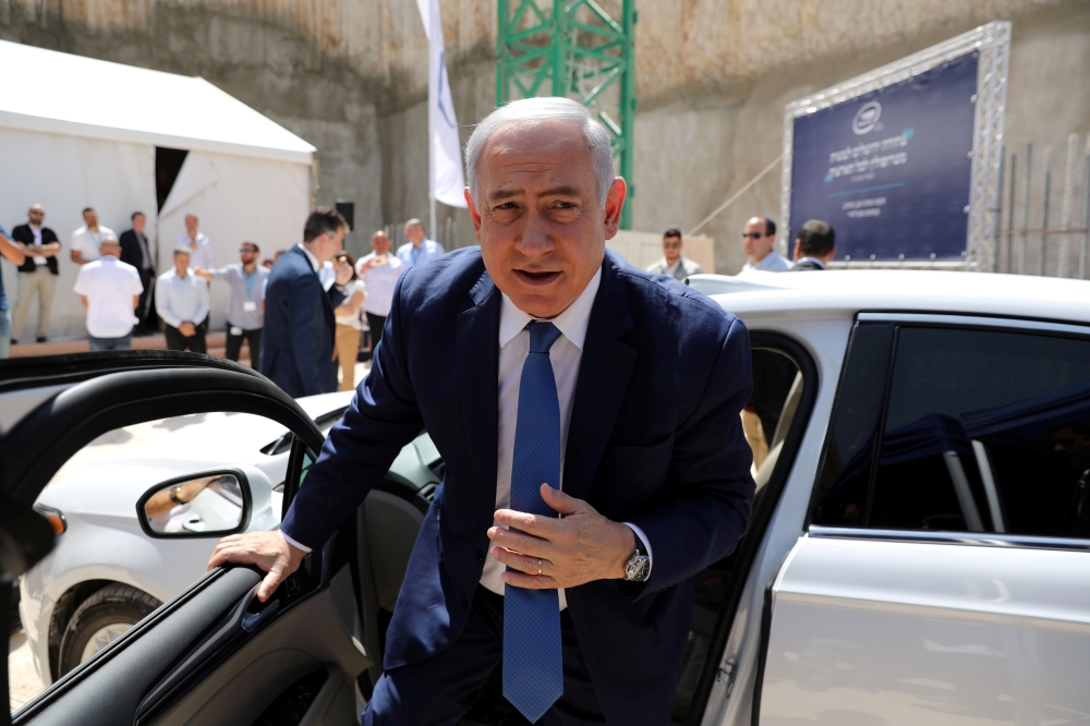 Israeli Prime Minister Benjamin Netanyahu exits an autonomous vehicle during a cornerstone-laying ceremony for Mobileye's center in Jerusalem on Tuesday. — Reuters