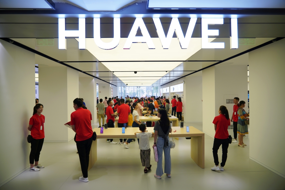 People visit a newly opened Huawei store in Xian, Shaanxi province, China, in this Aug. 22, 2019 file photo. — Reuters