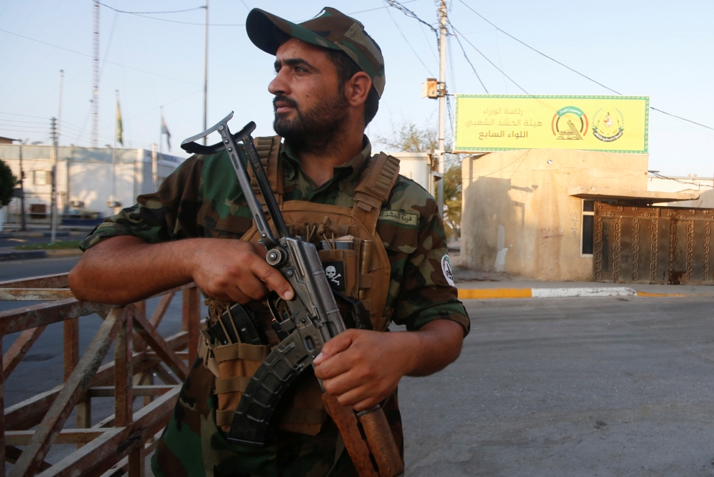 A member of Iraqi Popular Mobilization Forces (PMF) carries his weapon in Basra, Iraq, in this Aug. 26, 2019 file photo. — Reuters