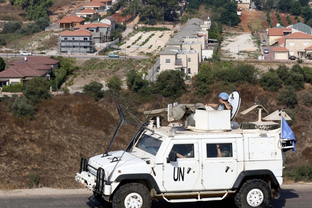 Soldiers of the United Nations Interim Forces in Lebanon (UNIFIL) patrol a road in the southern Lebanese village of Kfar Kila along the border with Israel overlooking the northern Israeli town of Metula on Wednesday. — AFP