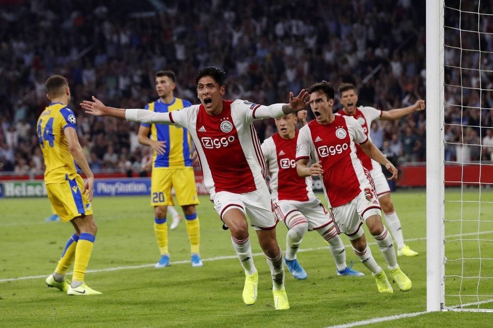 Ajax Amsterdam's Mexican forward Edson Alvarez (front) celebrates after scoring during the UEFA Champions League Group phase football match between Ajax Amsterdam and APOEL FC at the Johan Cruijff Arena in Amsterdam on Wednesday. — AFP