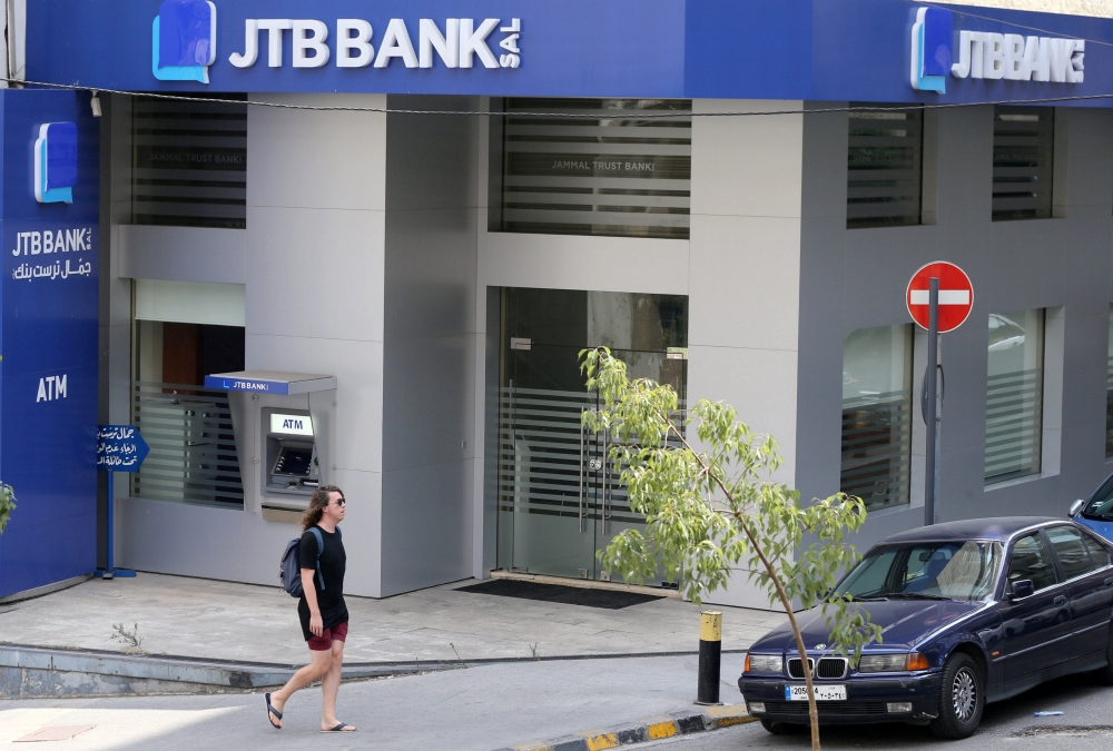 A pedestrian walks past Jammal Trust Bank (JTB) branch in Ashrafieh, Lebanon, on Friday. — Reuters