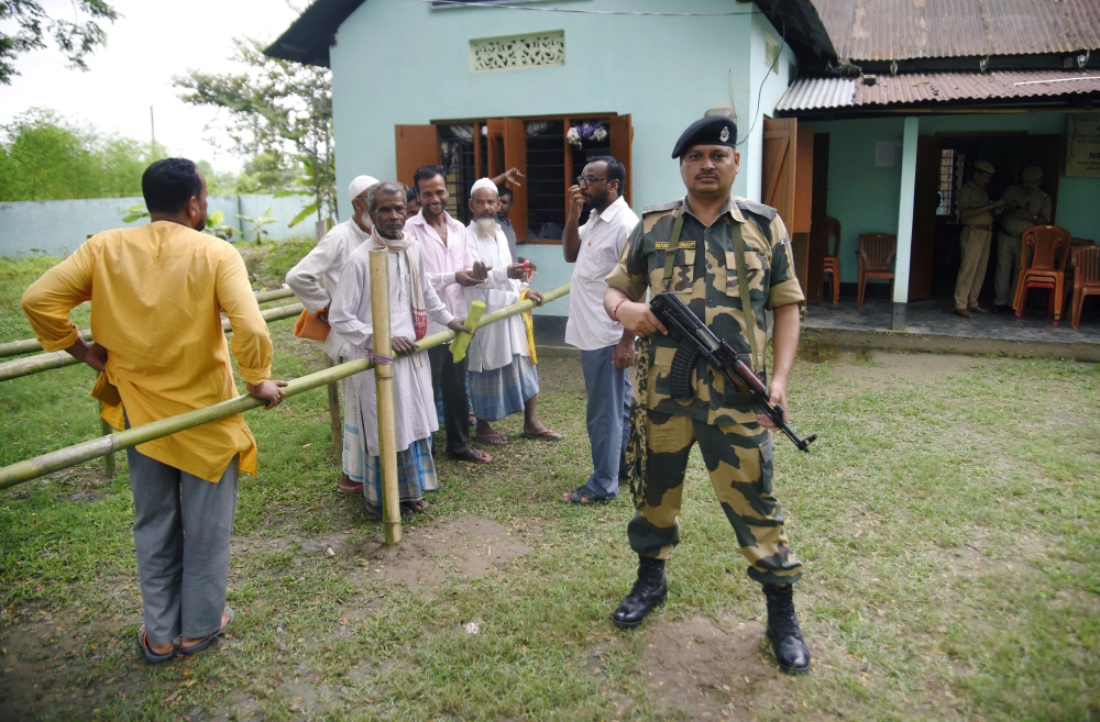 People stand in a queue to check their names on the draft list of the National Register of Citizens (NRC) outside an NRC centre in Rupohi village, Nagaon district, northeastern state of Assam, India on Saturday. -Reuters