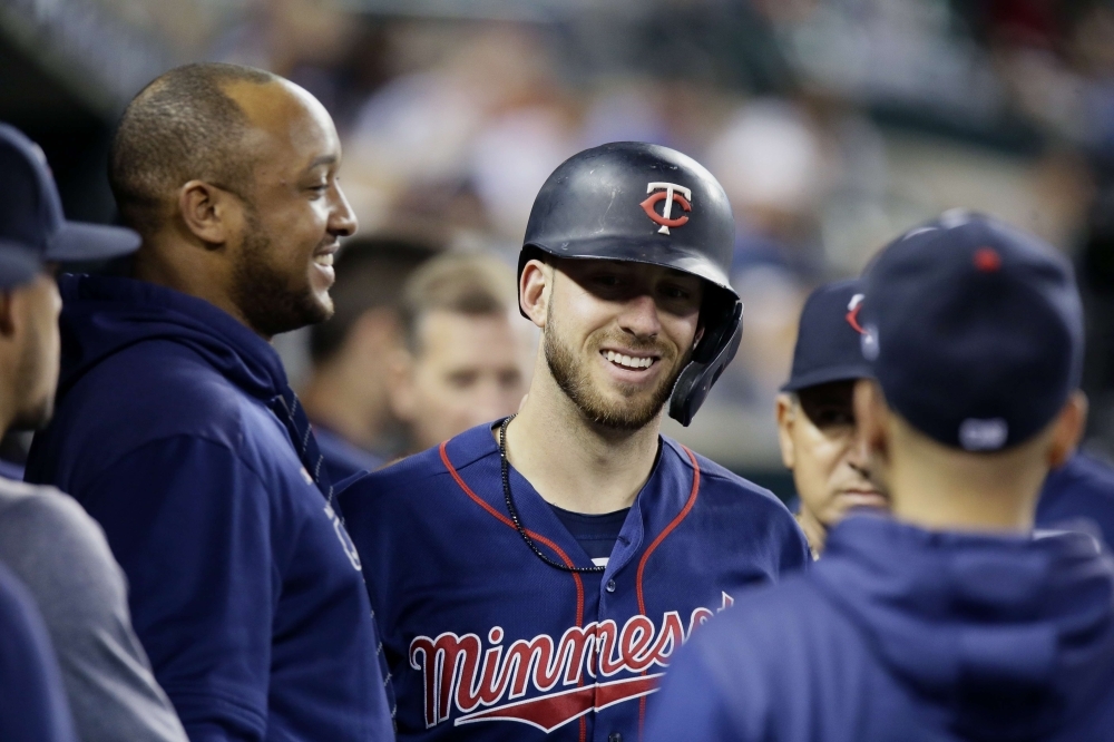 Mitch Garver No. 18 of the Minnesota Twins smiles in the dugout after hitting a home run against the Detroit Tigers during there ninth inning at Comerica Park on Saturday in Detroit, Michigan. The Tigers defeated the Twins 10-7. — AFP
