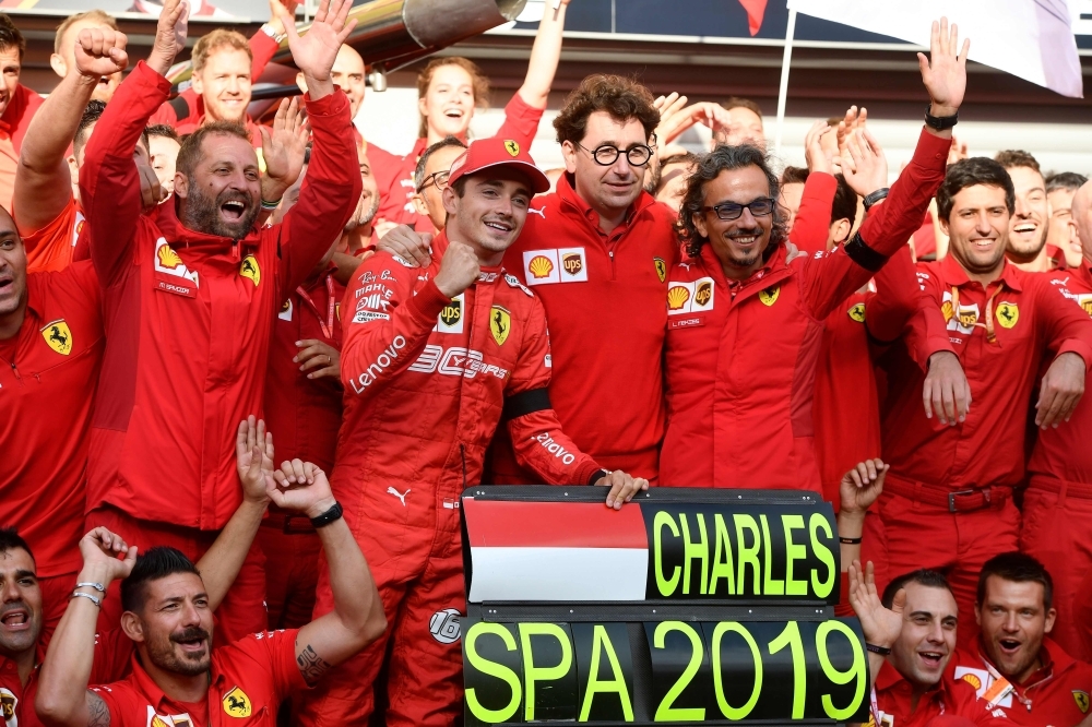 Winner Ferrari's Monegasque driver Charles Leclerc (C-L) and Ferrari's team principal Mattia Binotto (C-R) celebrate with team members after the Belgian Formula One Grand Prix at the Spa-Francorchamps circuit in Spa on Sunday. — AFP