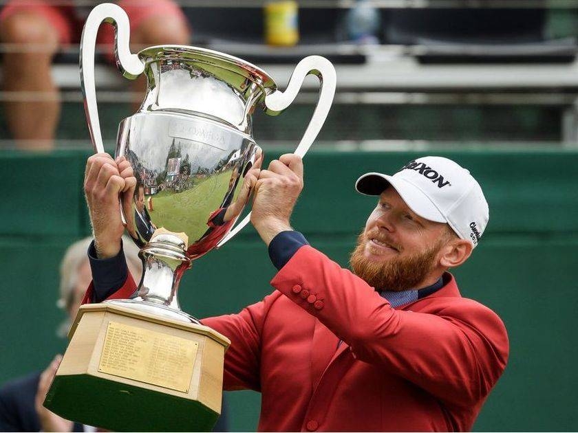 Sweden's Sebastian Soderberg raises his trophy after winning the PGA European Tour golf tournament Omega European Masters on Sunday, in Crans-Montana. — AFP