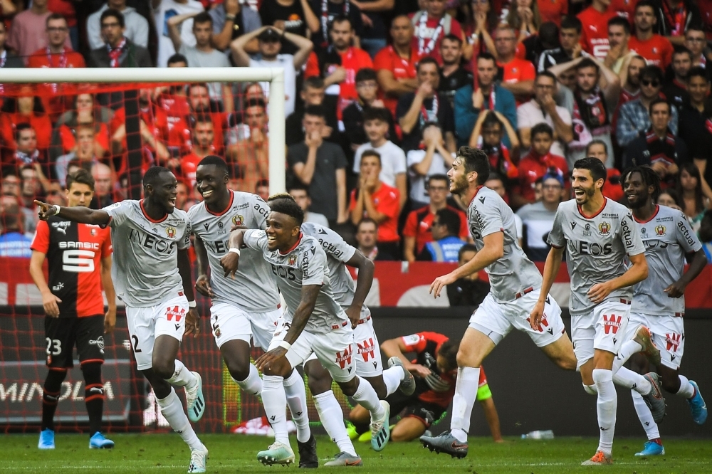 Nice's Senegalese defender Racine Coly (L) celebrates after scoring a goal during the French L1 football match between Stade Rennais and Nice, on Sunday at the Roazhon Park stadium in Rennes, western France. — AFP 