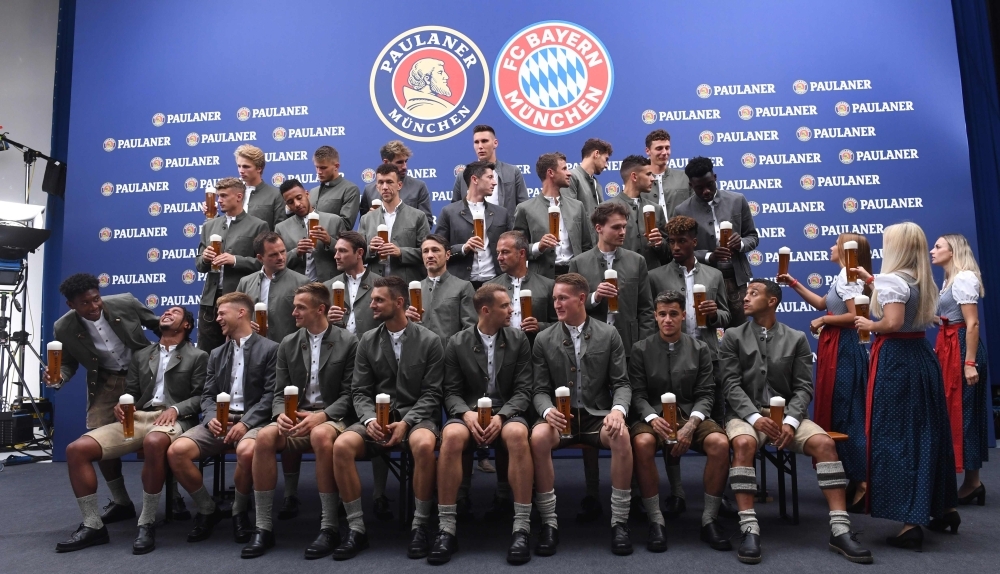 Team members of German first division Bundesliga football club FC Bayern Munich wear traditional Bavarian clothes as they wait for the start of a promotional photo shooting in Munich, southern Germany, on Sunday. — AFP