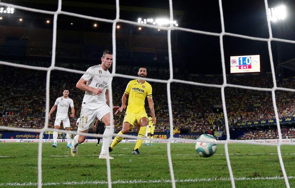 Real Madrid's Gareth Bale scores their first goal against Villarreal in the La Liga Santander at the Estadio de la Ceramica, Villarreal, Spain on Sunday. — Reuters