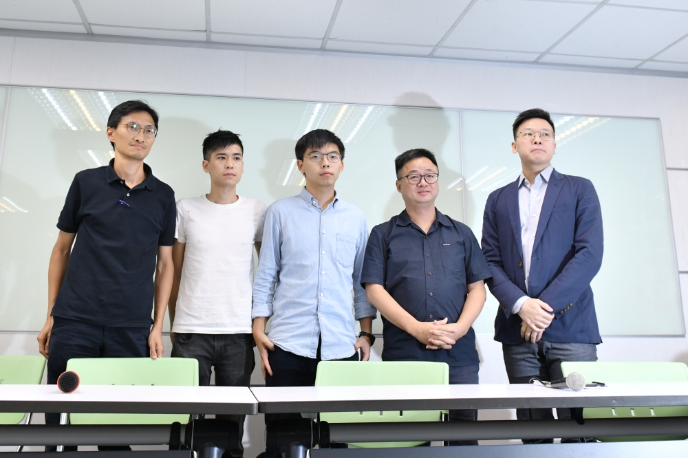 Pro-democracy activists Eddie Chu, Lester Shum, Joshua Wong, Democratic Progressive Party (DPP) Secretary-General Luo Wen-jia and Deputy Secretary-General Lin Fei-fan attend a news conference in Taipei, Taiwan on Tuesday. -Reuters