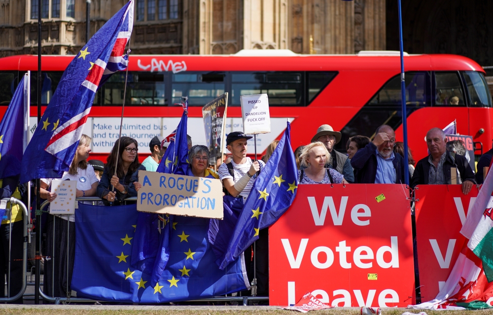 Anti-Brexit and pro-Brexit protesters stand outside the Houses of Parliament in London, Britain, on Wednesday. — Reuters