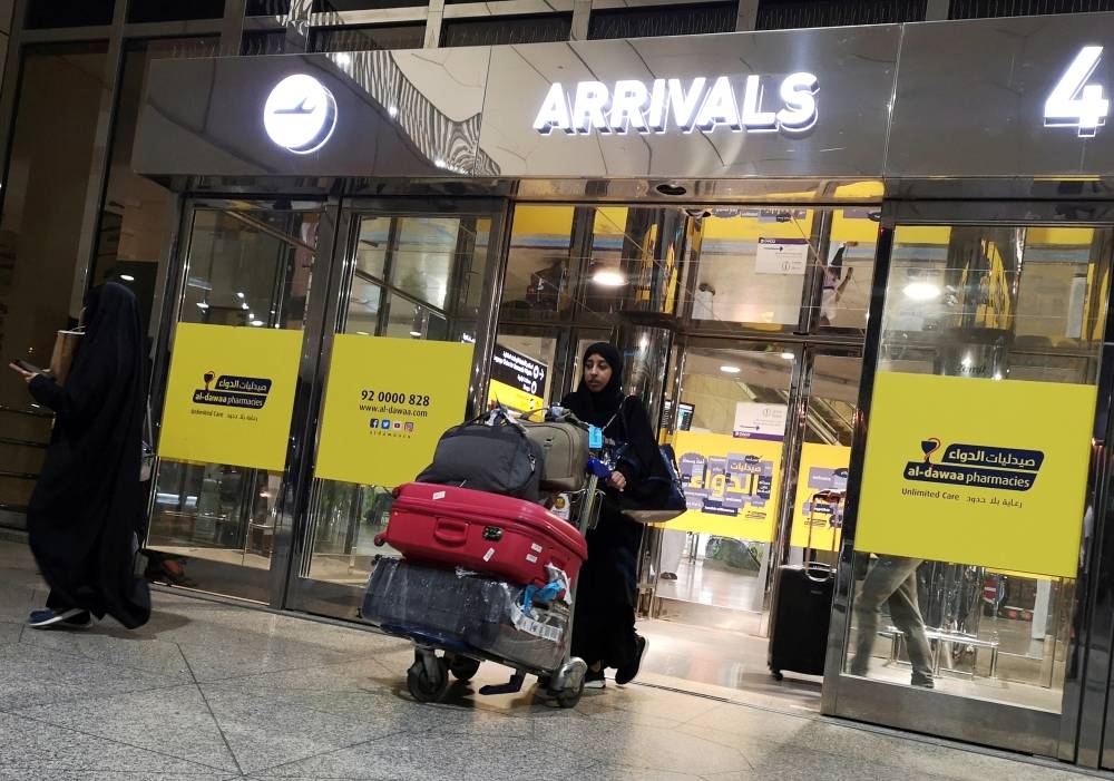 A Saudi woman is seen with her luggages as she arrives at King Fahd International Airport in Dammam, Saudi Arabia, August 21, 2019. REUTERS