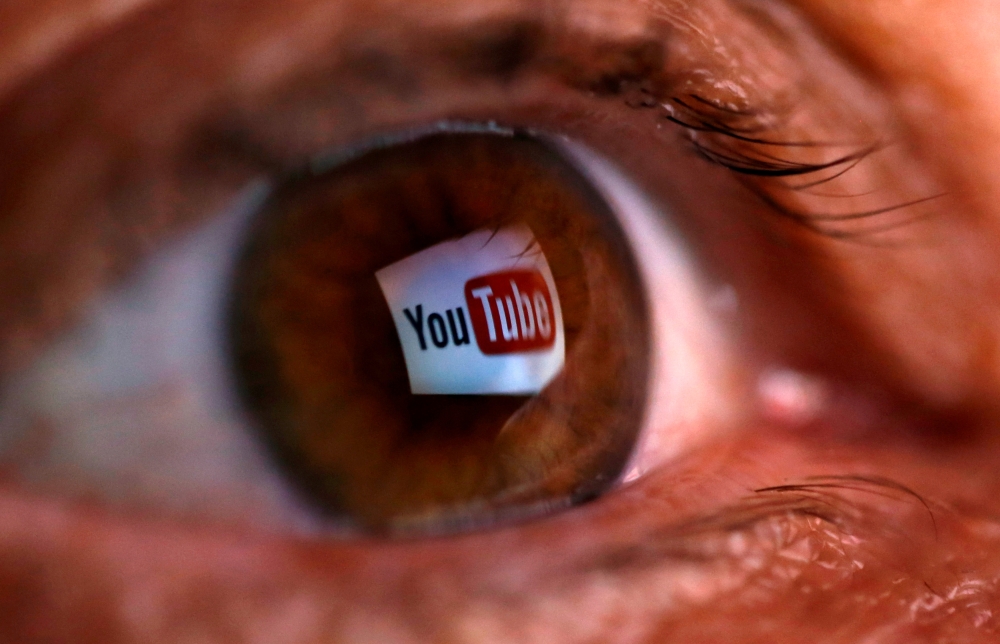 A picture illustration shows a YouTube logo reflected in a person's eye in this June 18, 2014 file photo. — Reuters