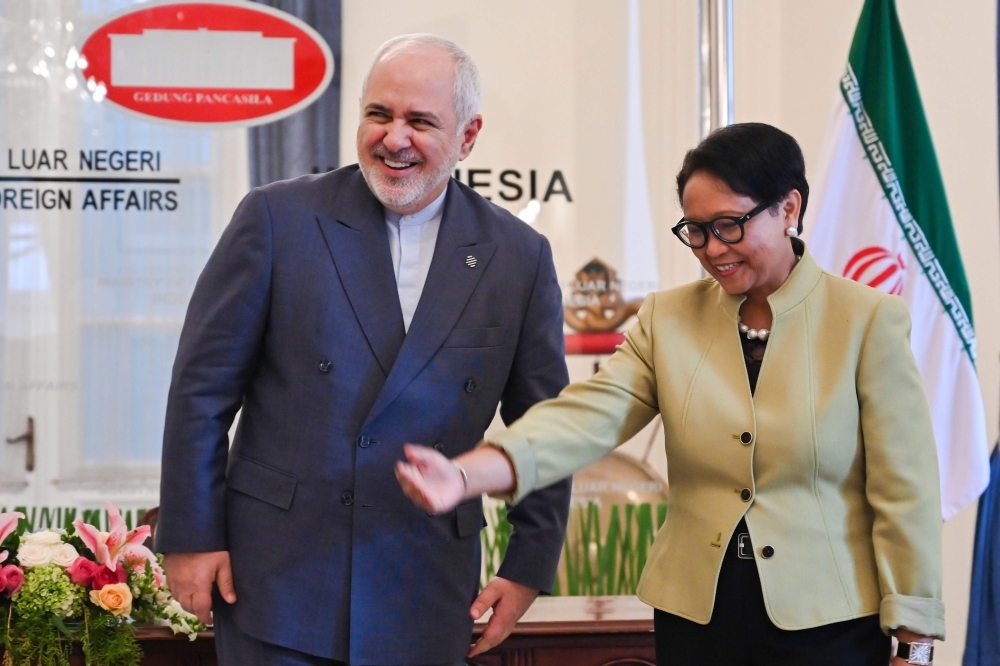 Indonesia's Foreign Minister Retno Marsudi, right, welcomes Iran's Foreign Minister Mohammad Javad Zarif, left, before their bilateral meeting in Jakarta on Friday. — AFP
