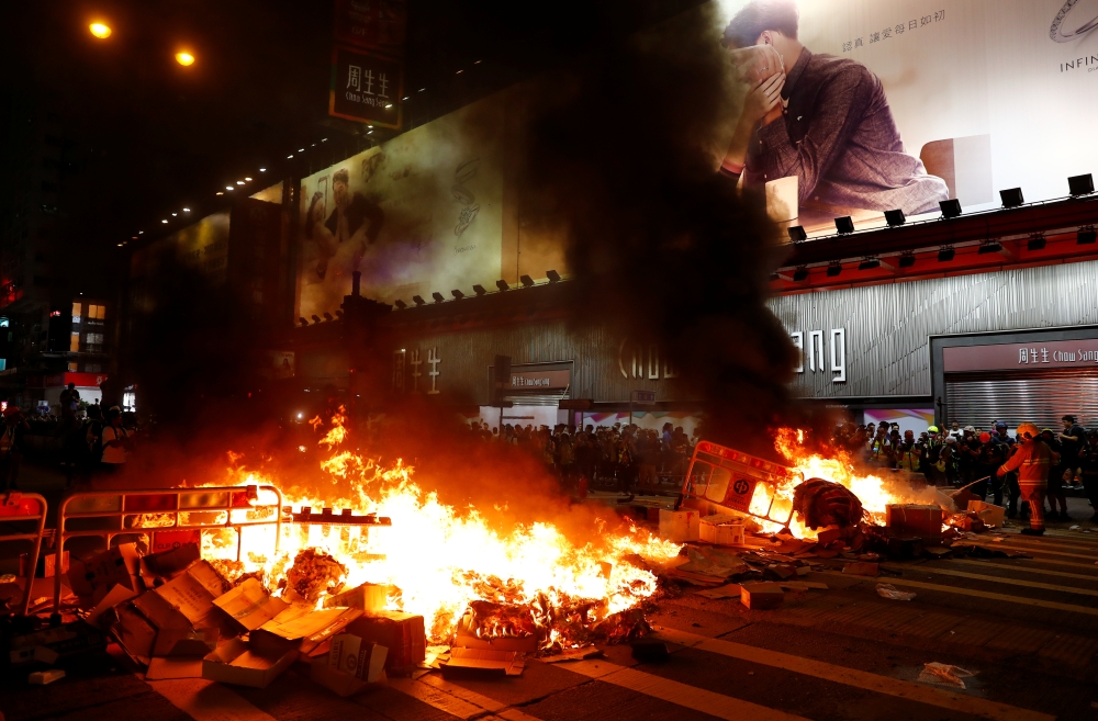 A burning barricade is seen during a demonstration in Mong Kok district in Hong Kong on Friday. — Reuters