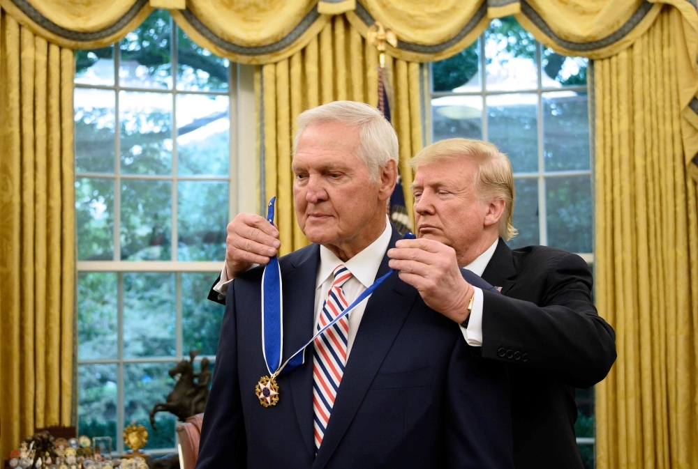 US President Donald Trump presents the Presidential Medal of Freedom to Los Angeles Lakers basketball legend Jerry Alan West in the Oval Office of the White House in Washington, DC on Thursday.  — AFP